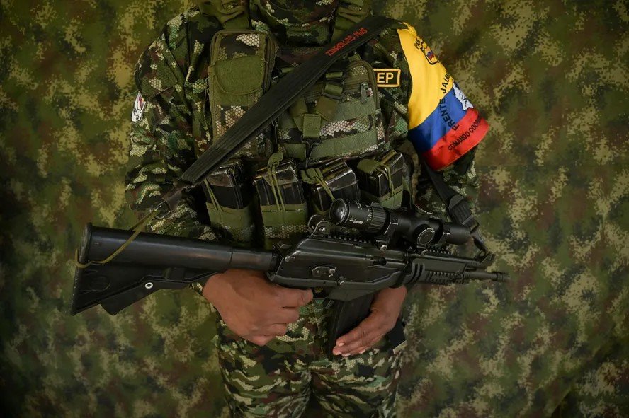 104127145-a-guerrilla-fighter-from-the-farc-dissidence-jaime-martinez-stands-guard-as-commander-andr.jpeg